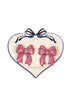 Heart-shaped card with pink sequin bow earrings on a white background