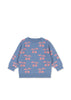 Blue sweater with pink cherry pattern on a white background