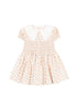 Soft cotton dress with puff sleeves, a lace collar, and smocked top part, made from organic cotton GOTS, displaying a floral pattern.