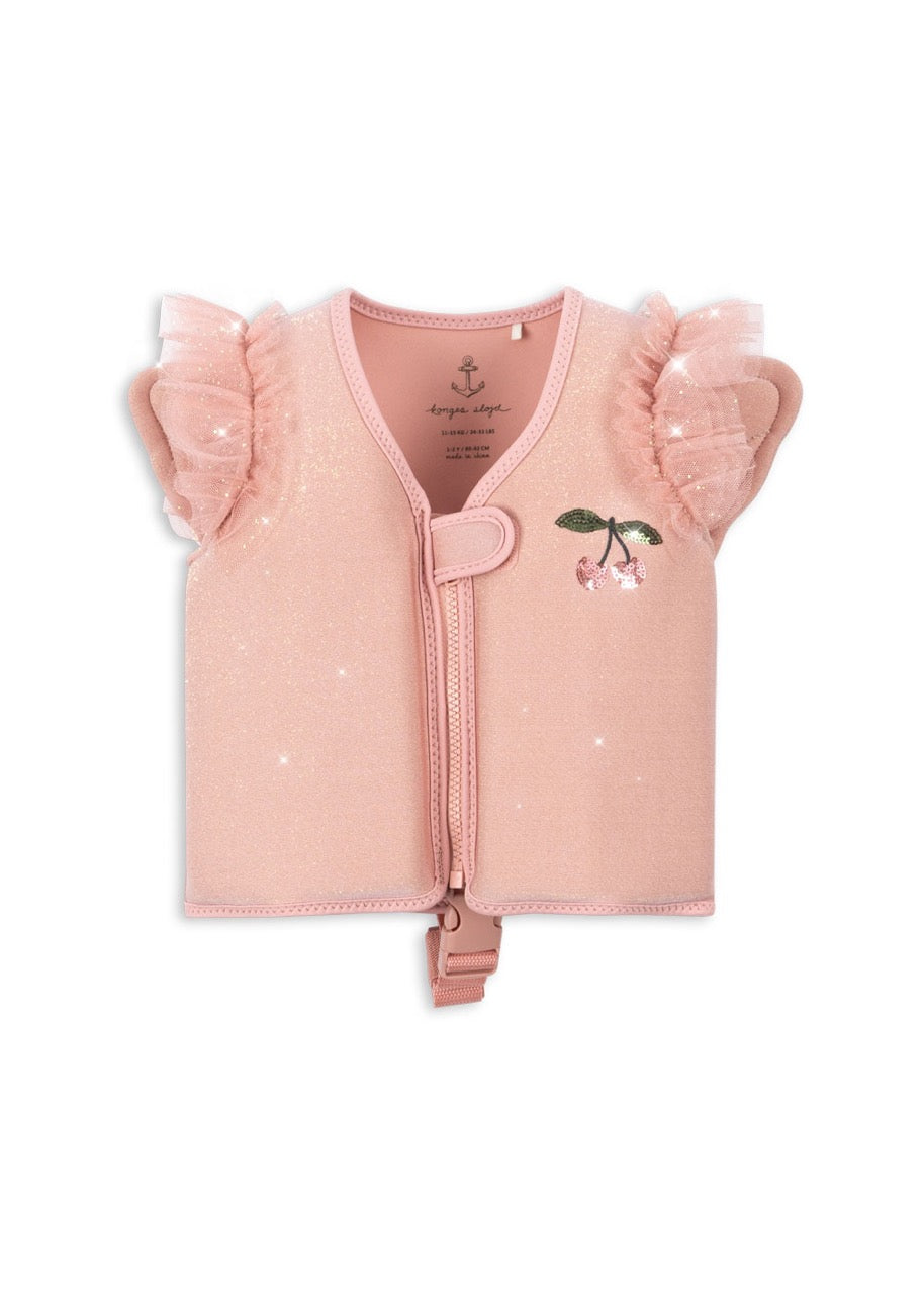 A powder pink swim vest for toddlers with tulle frills over the shoulders and a front zipper. The vest features a graphic of a cherry and a caterpillar.