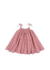 A short-sleeved dress with a floral pattern in pink and red colors, featuring tie straps and a smocked waist.
