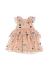A sleeveless, layered dress with a tulle skirt and sequin hearts pattern on a pink background.