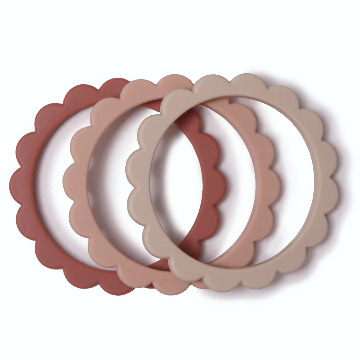 Set of three scalloped-edge silicone rings in pink and beige on a white background