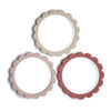 Three round decorative frames with scalloped edges in beige, pink, and red on a white background.