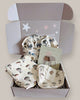 Baby gift set with blankets and toys in a box on a light background