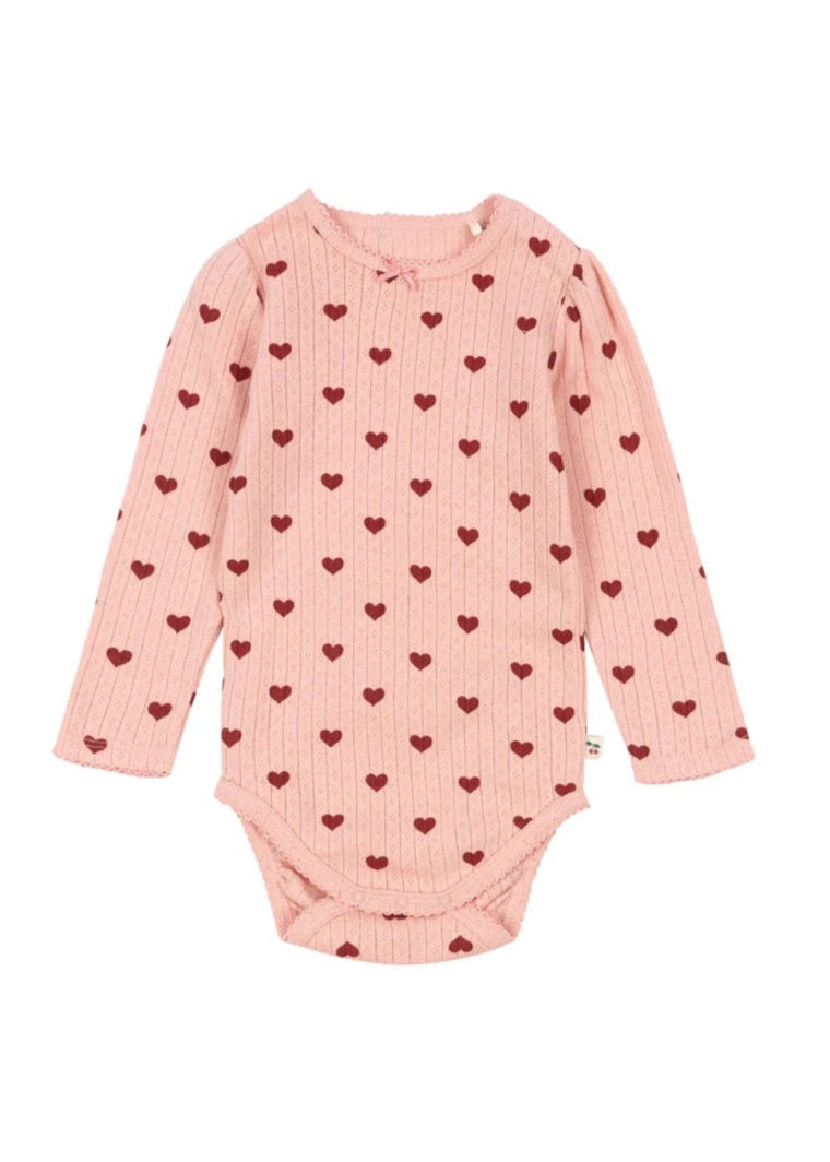 Pink baby onesie with heart pattern on a white background