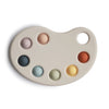 A gray paint palette-shaped toy with colorful bubbles in different shades placed on the palette.